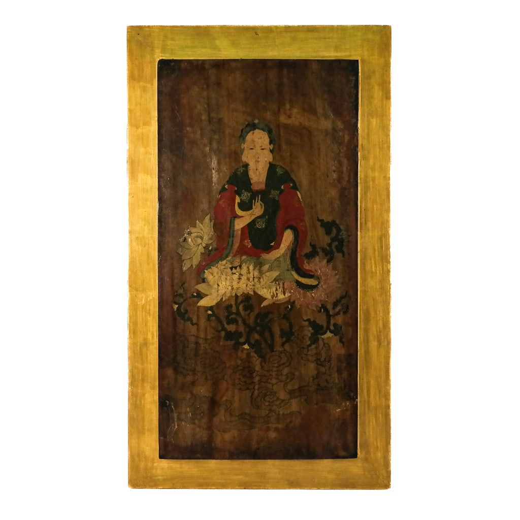 Chinese Painted & Lacquered Panel: Chinese painted and lacquered panel, late 19th / early 20th century, modeled as a Guanyin seated on a lotus flower throne, with gilt border, bearing faded labels verso. [25 1/2" H x 14 1/2" W]. Fading