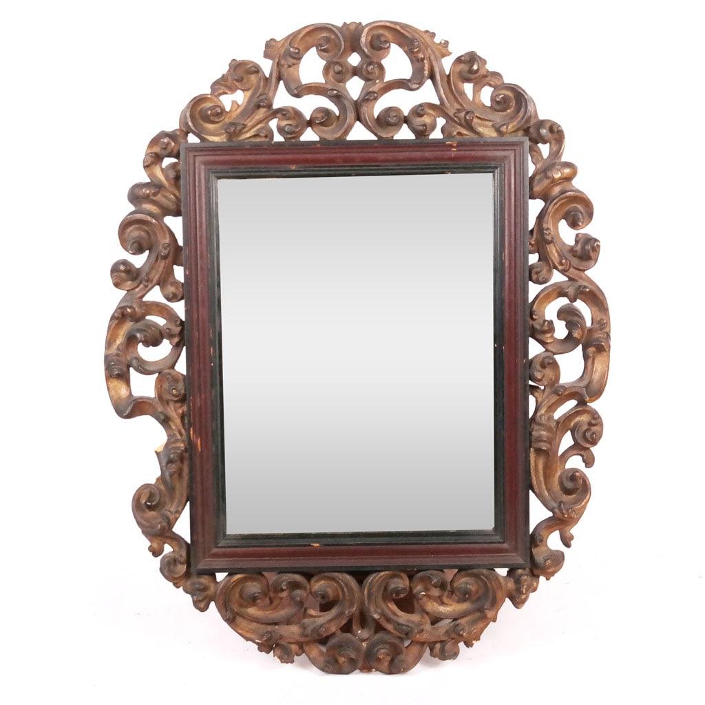 Continental Baroque-Style Carved Mirror, 19th C.: With exuberant scroll carving around the rectangular frame. [44 x 34 1/2 inches]. Several breaks and losses, mirror plate possibly later.