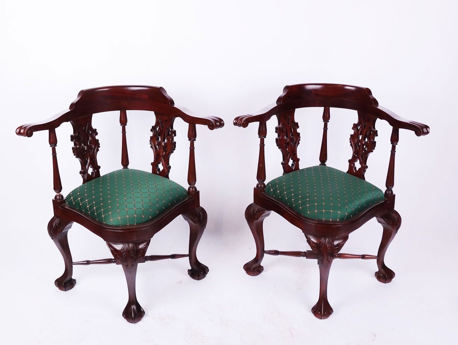 Pair of 70s Reproduction Corner Chairs: Pair of Chippendale-style mahogany corner chairs with stretchers and green slip seats. [33" H x 31" W x 23" D]. One "as-is".
