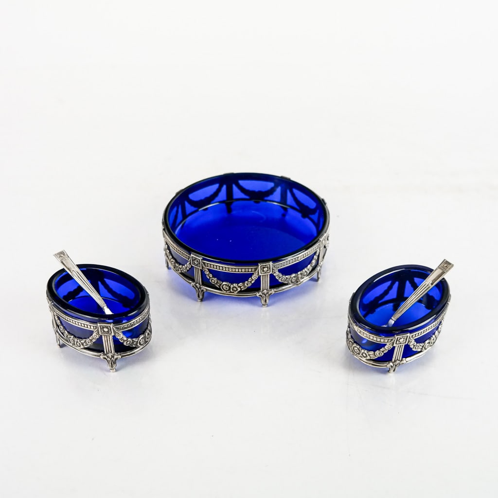 Three-Piece Salt Cellar Set: Three-piece salt cellar set comprising a master salt [4" Diam.] and a pair of small oval cellars with spoons, having cobalt liners with star hallmark.