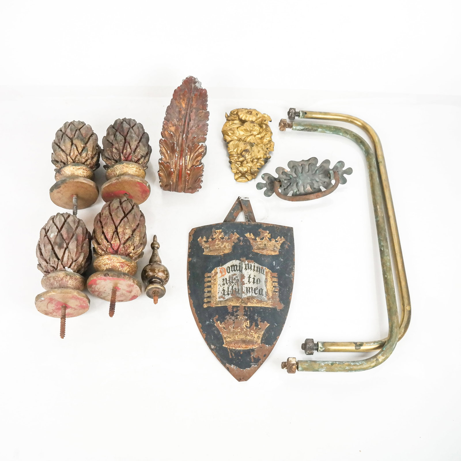 Group of Home Decor Accesories: Group of decorative accessories, such as carved pineapple finials, tie back handles, and others. [Largest: 11" H x 16 1/2" W x 6" D]. In distressed condition.