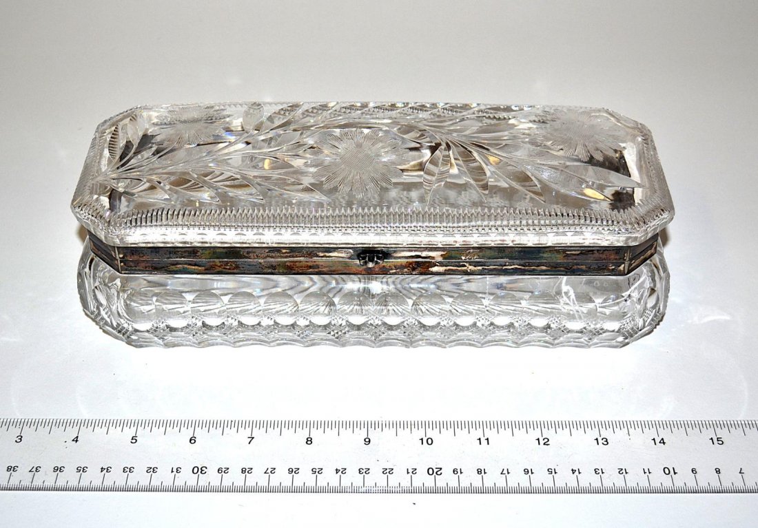 Cut Crystal and Sterling Silver Jewelry Box: Oblong cut crystal jewelry box with floral decor and sterling silver fittings. 11" W x 4 1/2" D x 3 1/2" H.