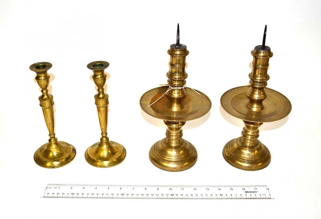 Two Pair Brass Candlesticks: Comprises a pair of colonial style prickets with wide rims [12 1/2" h] and a pair of traditional turned candlesticks. All in good condition