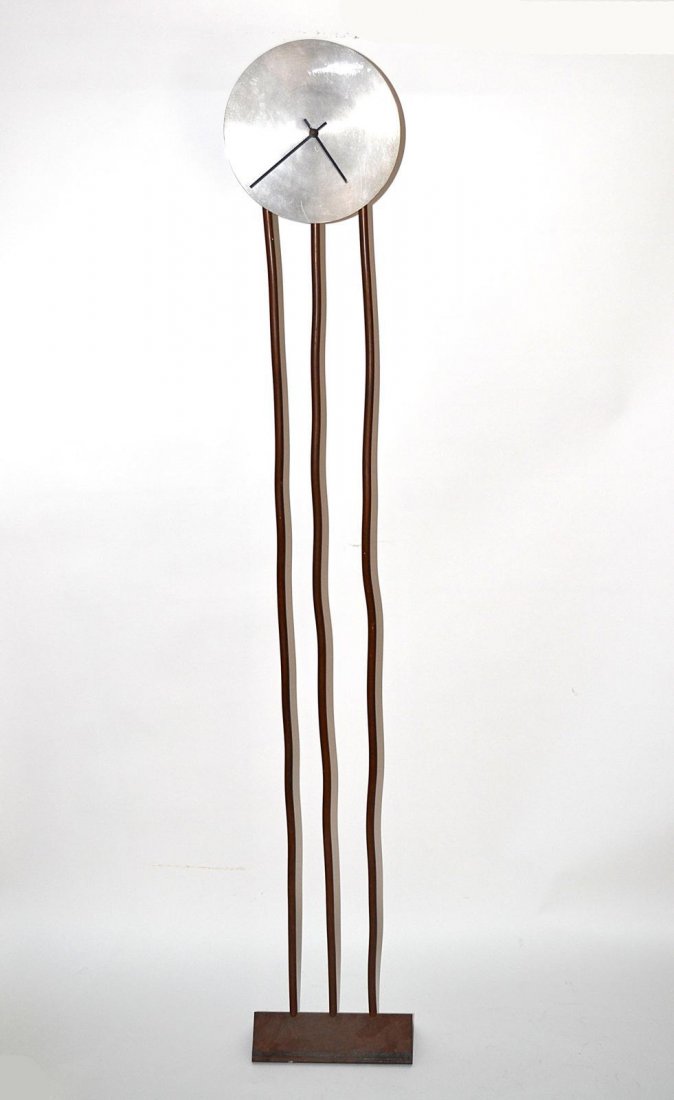 Memphis Standing Clock: 20th century modern floor stand clock, having three shaped copper columns & a steel face with metal black hands. Good condition - some wear. 59 1/2"H x 9"DIA (face).