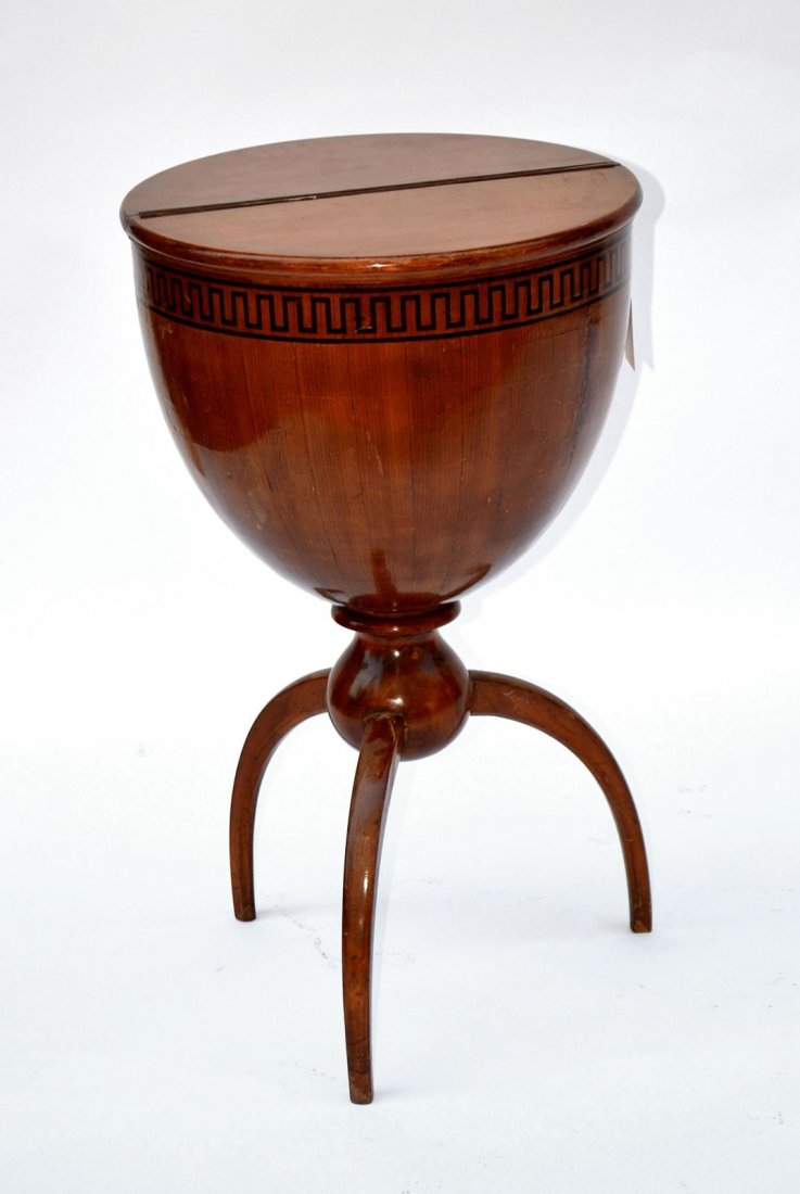 Biedermeier-Style Sewing Cabinet: Walnut ovoid cabinet with hinged demilune tops, inlaid Greek key band and tripod supports. 16 1/4" Dia xx 27 3/4" H. In good condition.