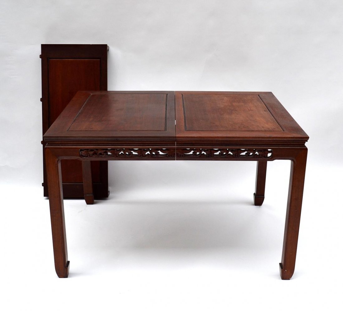 Chinese Dining Table: Features carved apron with leaves and berry motif, floating panel top, and one 18" wide leaf. 42" x 50" [closed] x 31" H. In very good condition.
