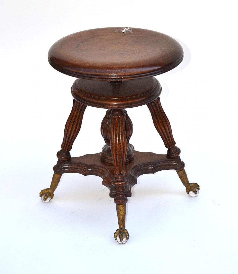 Victorian Piano Stool: Mahogany revolving adjustable piano stool on claw feet with glass balls. 14 1/2"DIA x 17 1/2" - 21"H.