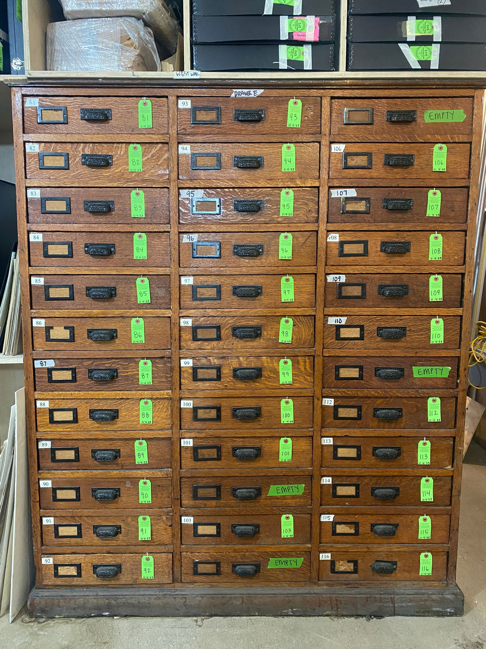 Monumental Victorian Oak 36-Drawer Cabinet: Large antique Victorian oak flat file cabinet, having three columns of 12 drawers with ornately carved brass pulls. Provenance: Phyllis Lucas Gallery, NYC. [(Approximately) Overall: 69 1/2" H x 58" W