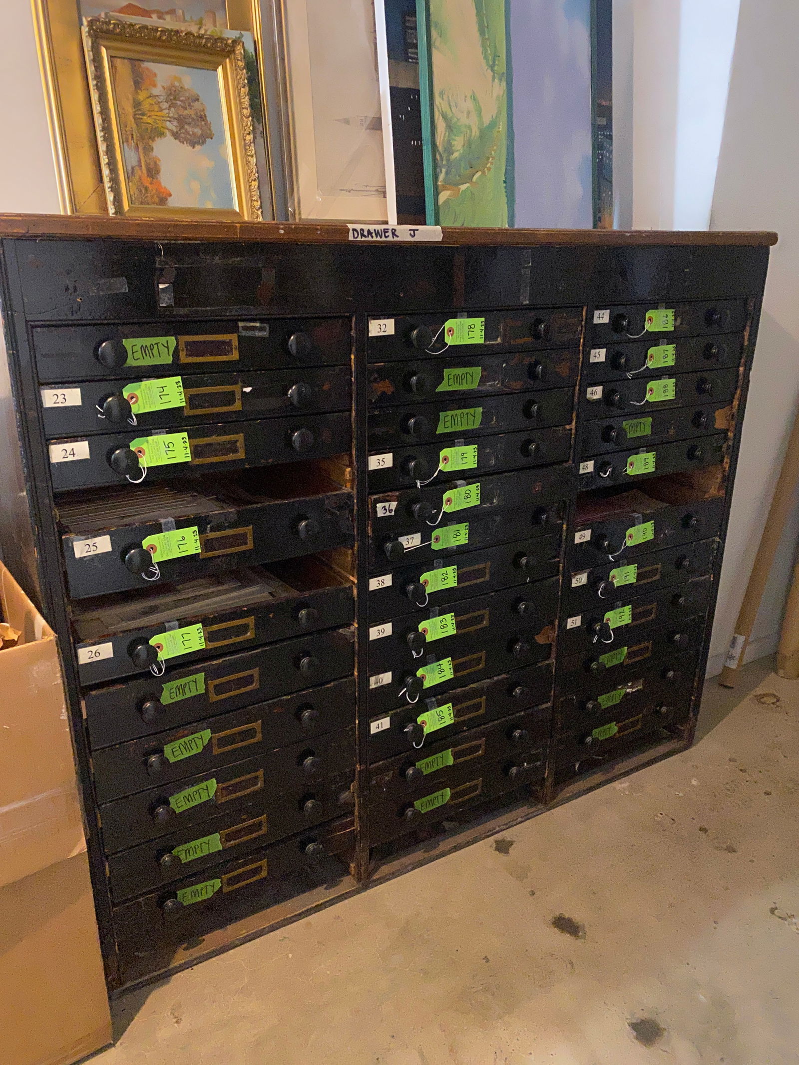 Large Antique Painted Oak Flat File Cabinet: Large antique black painted oak flat file cabinet, having three columns of 13 drawers each (some missing). Provenance: Phyllis Lucas Gallery, NYC. [(Approximately): 50" H x 59 1/4" W x 21" D]. Missing