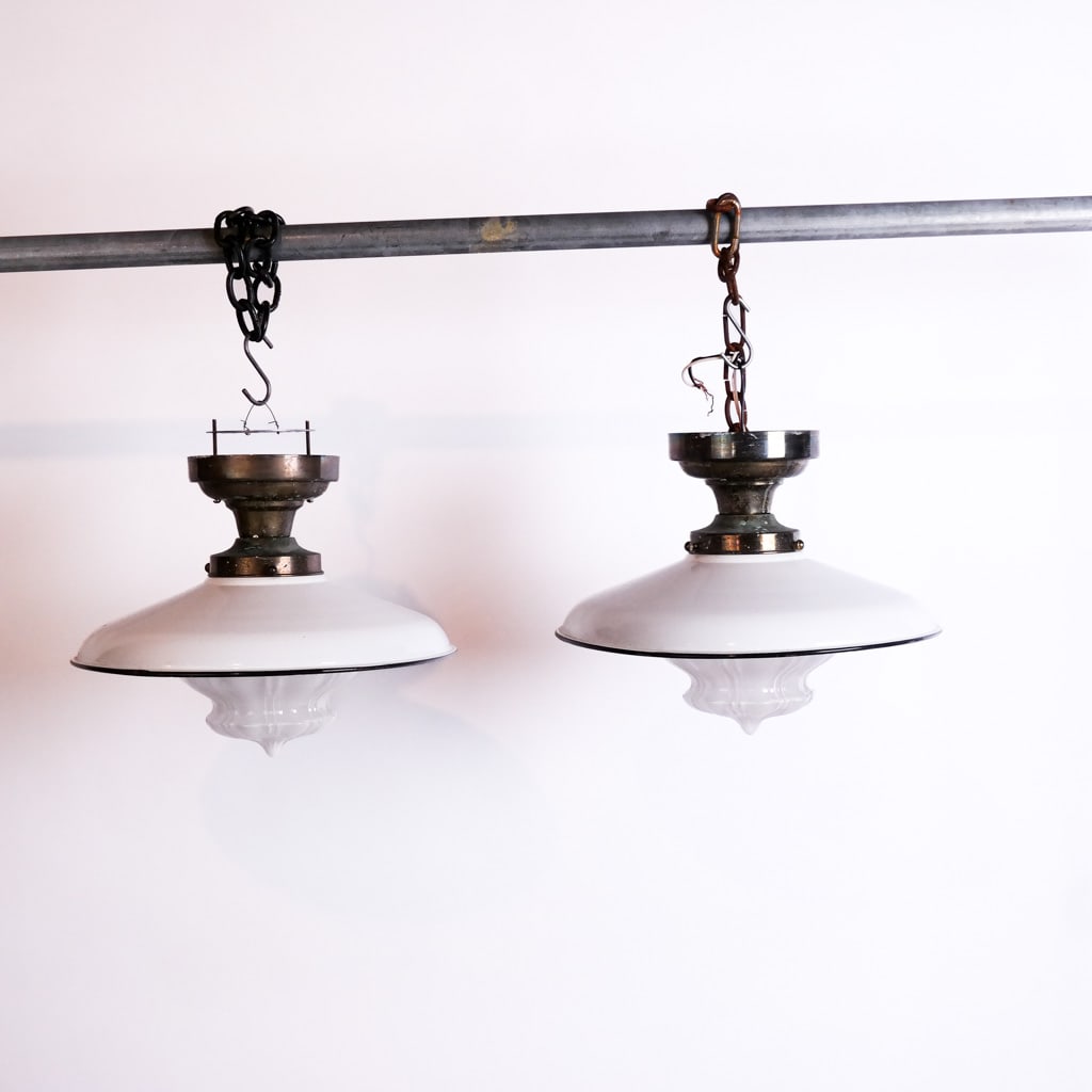 Pair of Vintage Enameled Metal Lanterns: Pair of vintage enameled metal schoolhouse lanterns, first half of the 20th century. [14 1/2" H x 15" Diam.]. Oxidation to brass tops; residue, losses and wear to decoration.