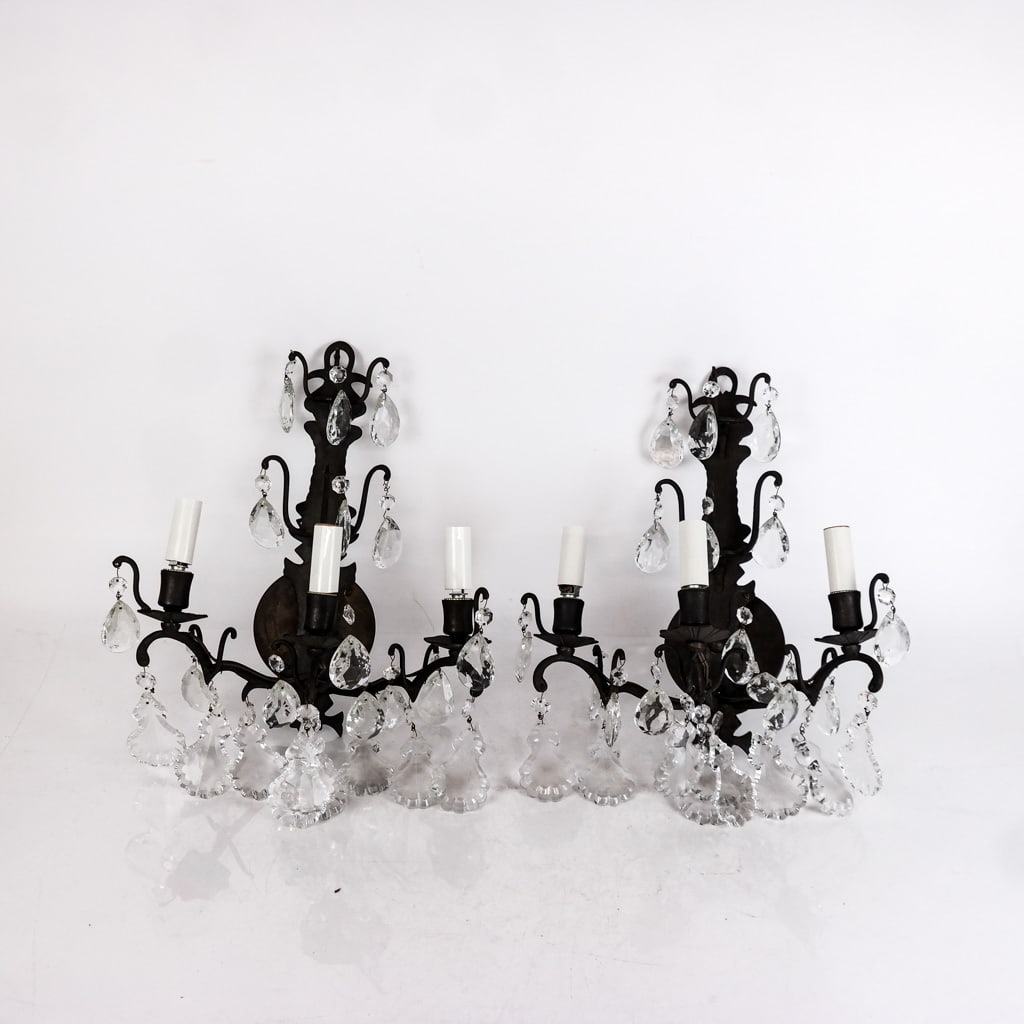 Pr of Rococo-Style Wrought Iron and Glass Sconces: 2nd half 20th century, with faceted prisms. [16 1/2 x 12 1/2 x 7 3/4 inches]. Light oxidation to frame, scuffs to prisms.