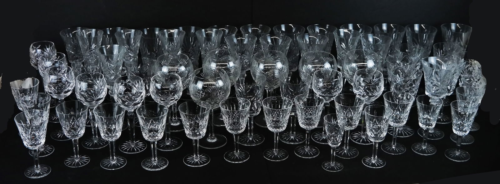 Assembled Group of Waterford Crystal Stemware (66): Assembled group of 66 pieces of Waterford crystal stemware, in Lismore and other patterns, including wine goblets, water glasses, and liqueur/cordials, most with faint mark to bases. [Tallest: 9" H x