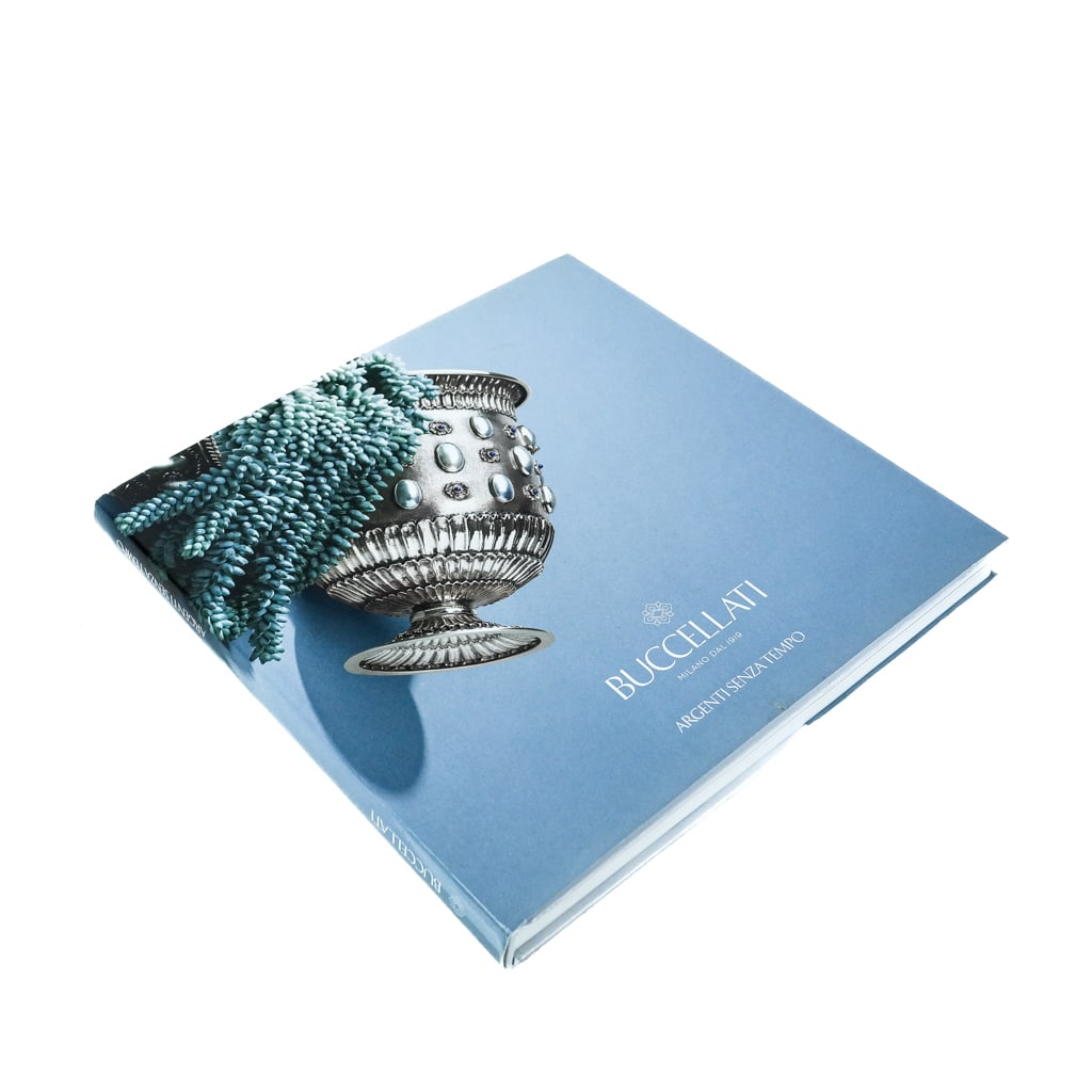 BOOK: "Buccellati: Argent Senza Tempo": Reference book of the famed Italian silver maker, with pictures. '11" x 11"]. Wear and losses to dust jacket and cover.