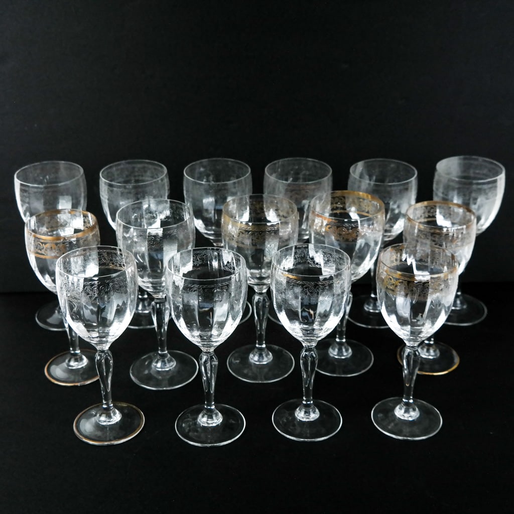 Set of 15 Etched Crystal Stems: Set of 15 etched crystal stems, some partially gilt, some fully, cleaned, all in the same pattern. [7" H (x6); 7 1/2" H (x9)].