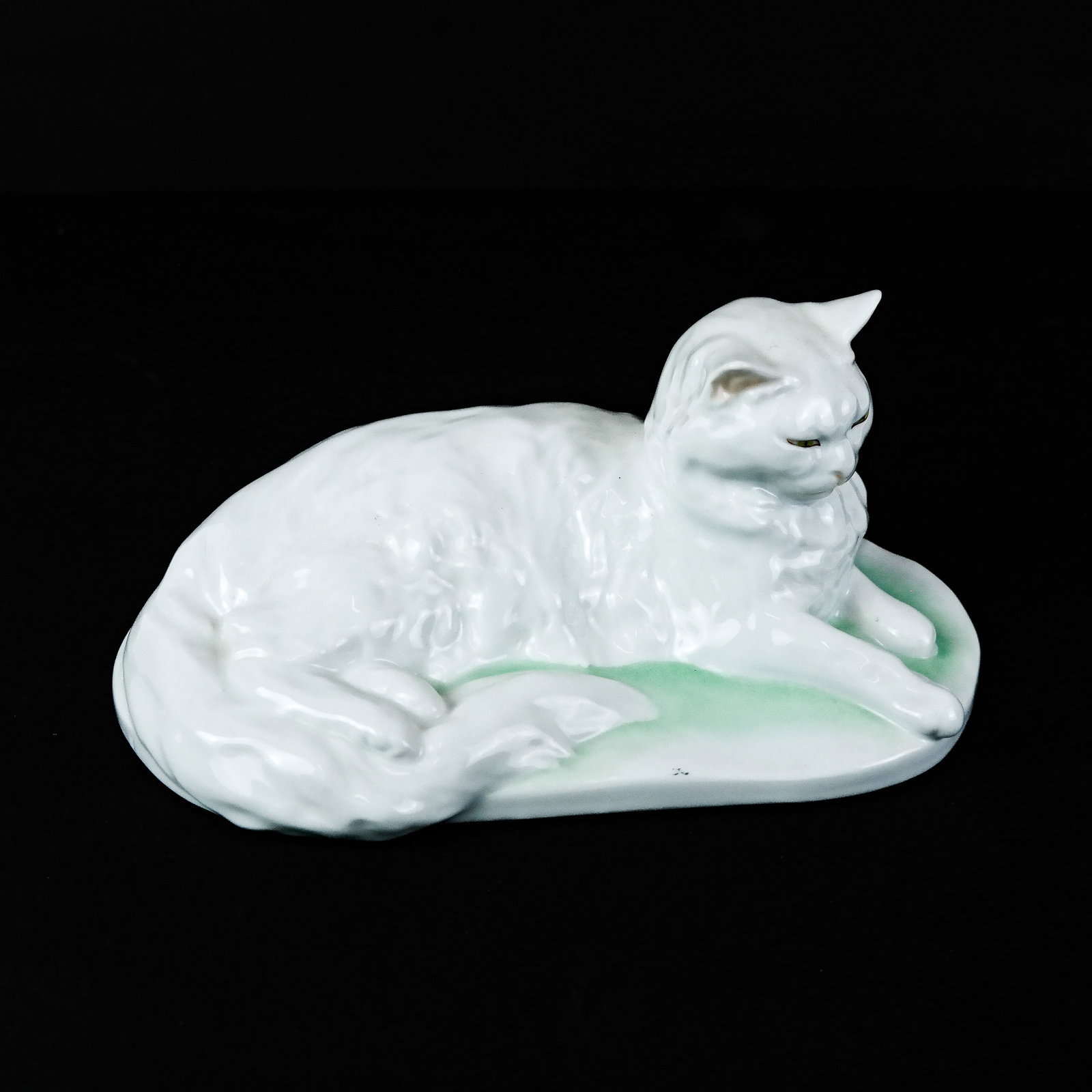 Herend Porcelain Recumbent Cat: Herend white cat on green and white self base. [4 1/2" H x 5" W x 9" D].