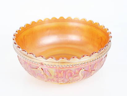 Carnival / Depression Glass Relief Bowl: Carnival / Depression glass relief bowl, early 20th century, having a scalloped rim and beaded details above scenic bird raised decoration within lush foliage on orange iridescent glass with ambergina