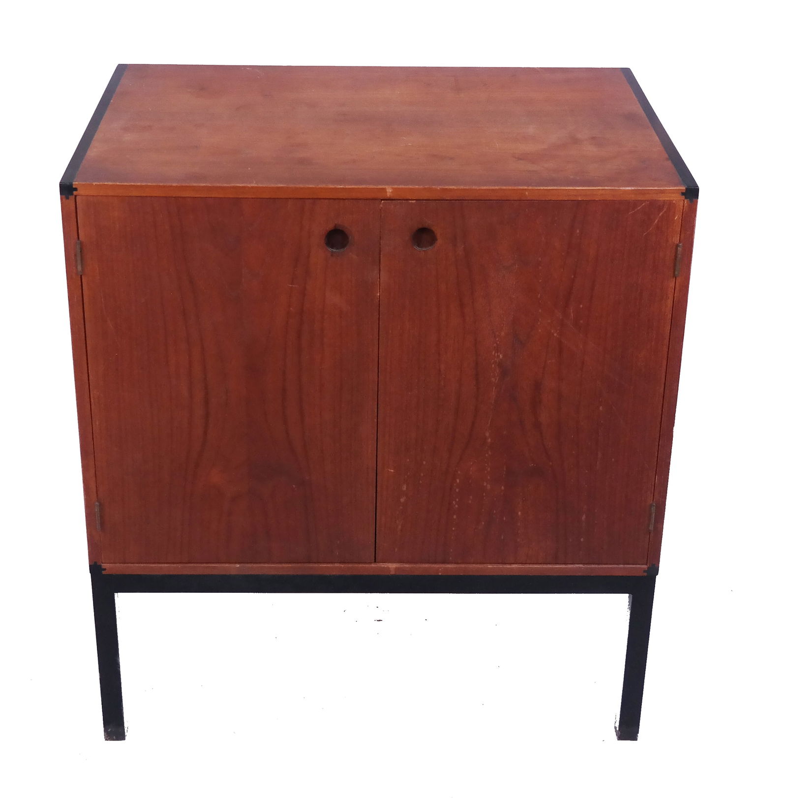 Mid Century Teak Nighttable Cabinet: Mid Century teak nighttable cabinet in the Danish style, having two cupboard doors with interior shelves, raised on ebonized metal frame. [27 1/2" H x 25 1/4" W x 17 1/4" D]. Fading, losses to finish,