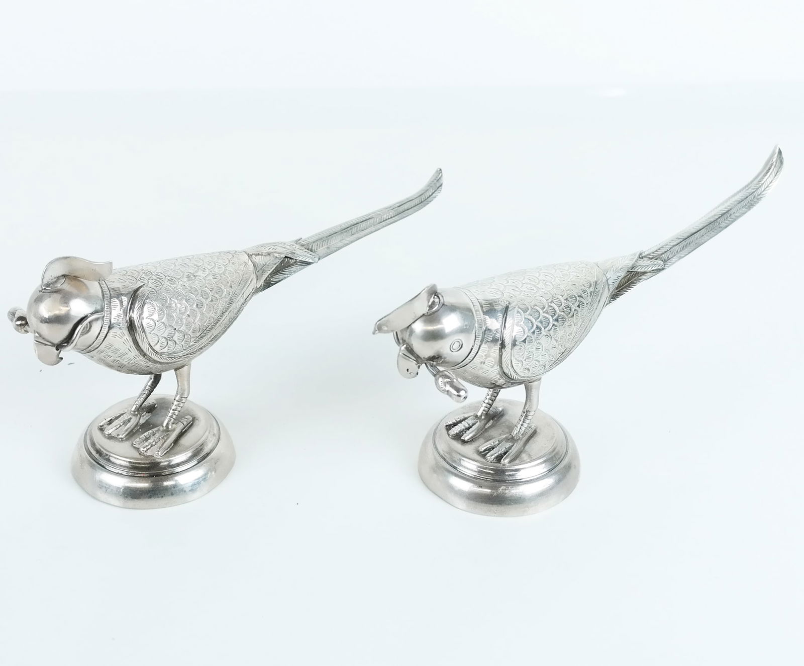 Pair of Very Unusual Pheasant Dispensers: Pair of very unusual pheasant dispensers, in unmarked silver, having feather designs and screw-off head feather tops, likely for oil and vinegar. 15 ozt. inclusive.; [4" H x 2 1/2" W x 9" D].