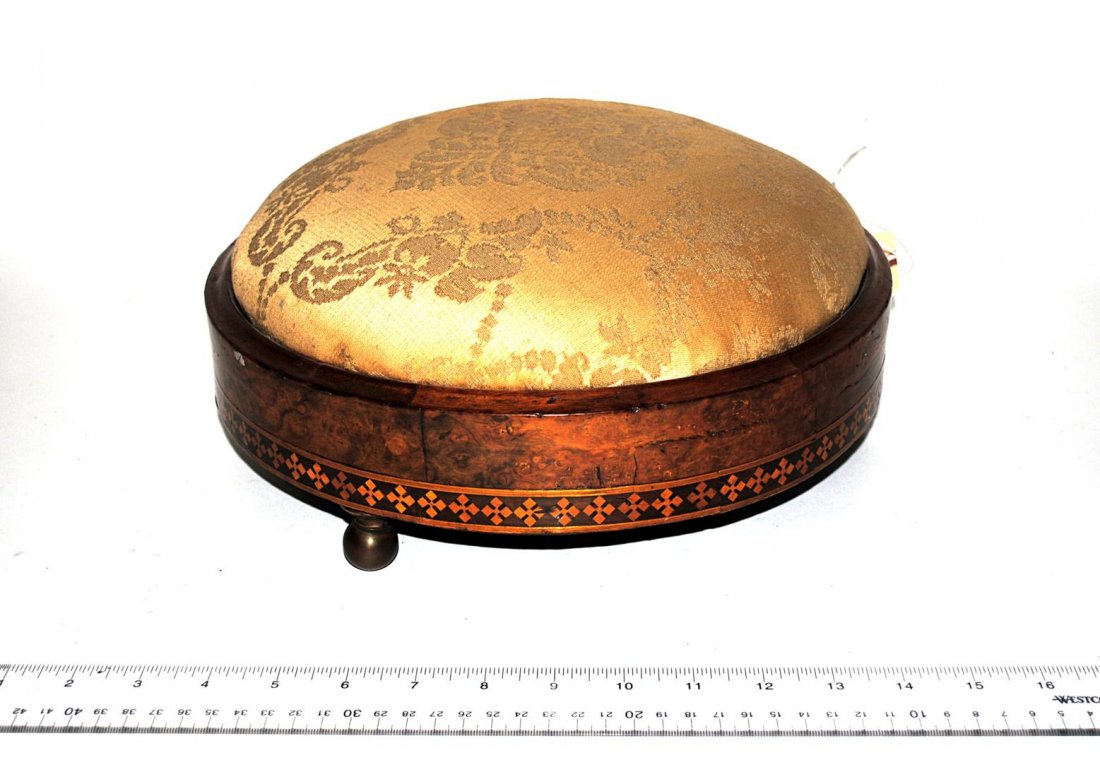 Regency Footstool: Burl walnut inlaid foot stool with green upholstery. Good as with age. 12" Dia x 4" H.