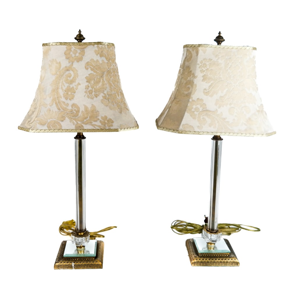 Pair of Gilt Metal Mounted Glass Table Lamps: 20th century, with fluted standards on mirror bases with filigree pierced details. With damask pattern shades. [21 1/2 x 4 1/2 x 4 1/2 inches]. Dents, bending, residue to bases.