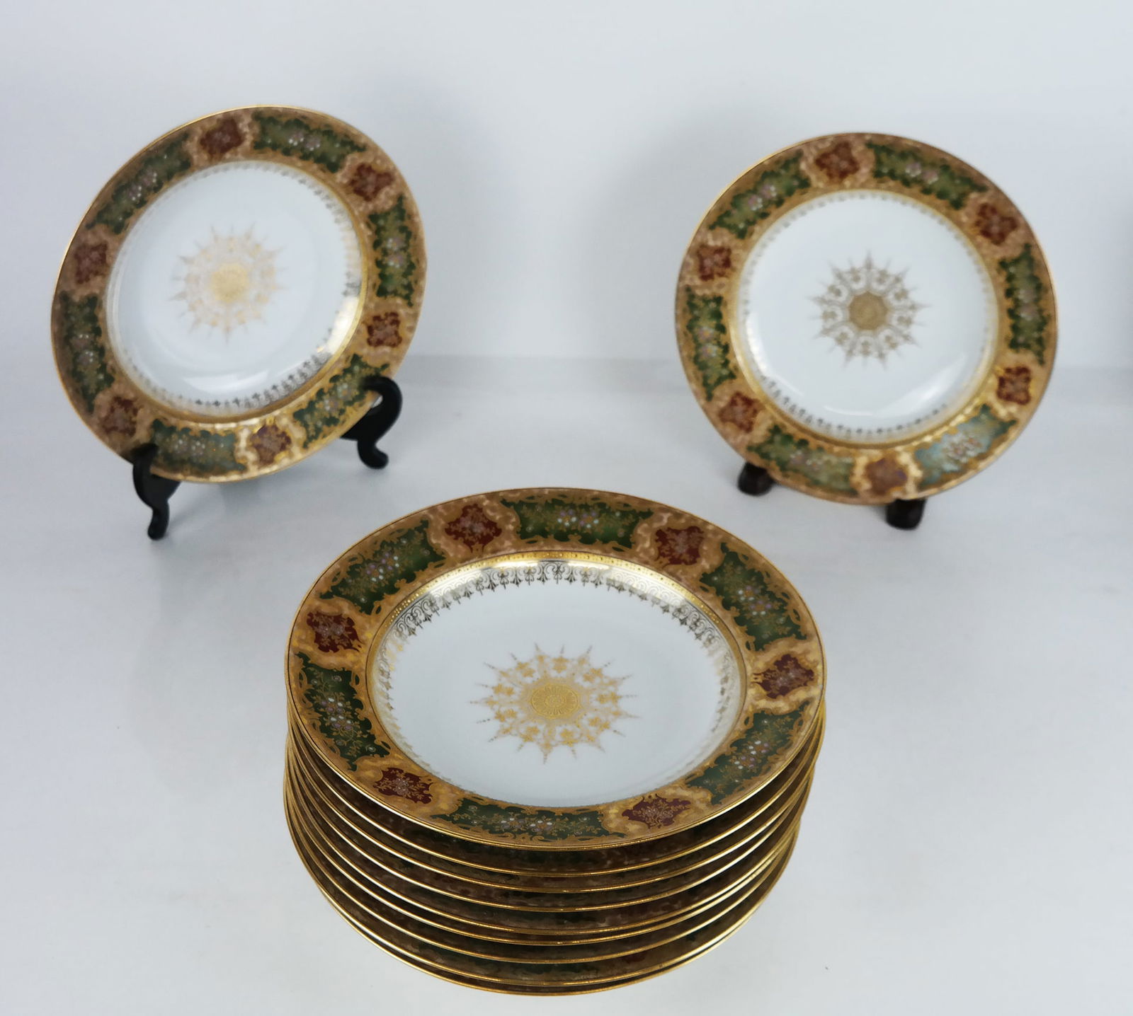 Fisher & Meig of Pirkenhammer Soup Bowls: Fisher & Meig of Pirkenhammer porcelain soup bowls, circa 1910, retailed by Ernst Wahliss, Vienna, with fine gilt-accented floral border and medallion, some with partial "F&M" impressed mark or green