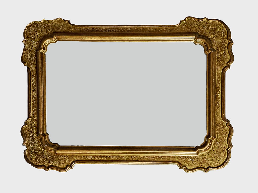 Carved Giltwood Mirror: Carved giltwood mirror, late 20th century, with floral and foliate motif border. [54" H x 39 1/2" W]. Losses and wear to gesso.