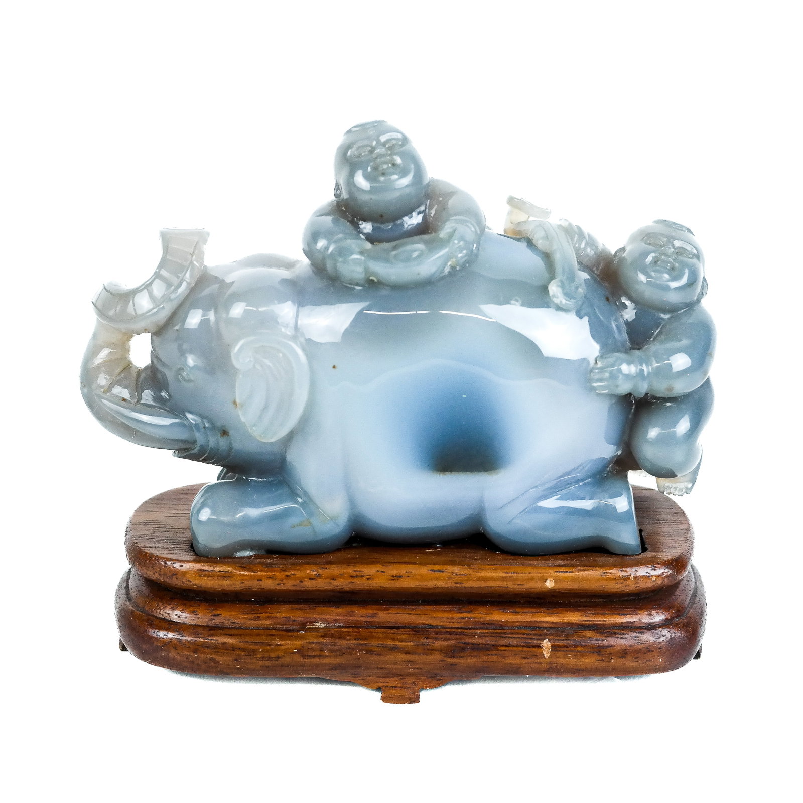 Chinese Elephant Carved Water Agate Sculpture: Chinese carved water agate sculpture, 20th century, modeled as an elephant with two riders, mounted on a wood stand. [Overall: 6 3/4" H x 8" W x 3 1/2" D].
