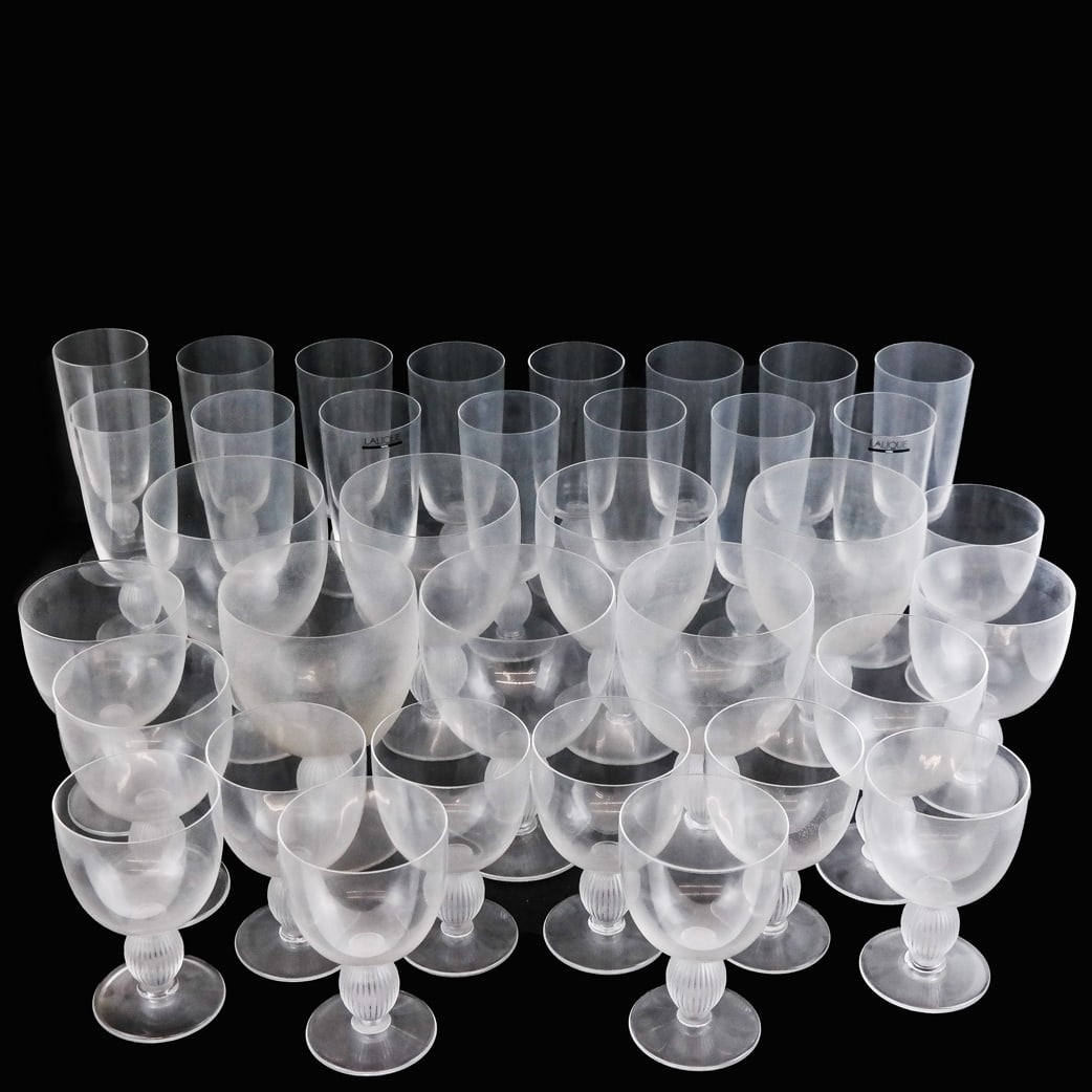 Lalique French Glass Stemware (38 Pcs.): Lalique French glass stemware, in the "Langeais" pattern, comprising champagne flutes, water goblets and wine glasses, bearing etched signature to base, some with original stickers. 38 pieces. [9 glas