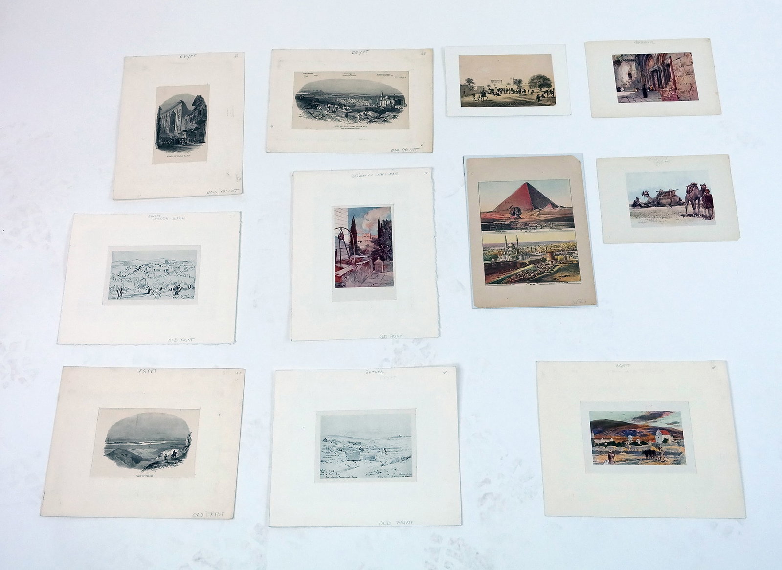 Group of Vintage Egypt Prints (11 Pcs.): Group of 11 vintage colored and black and white prints depicting various scenes of Egypt, including Cairo, the Nile, Thebes, pyramids, sphinx, camels, mosques, and others. All unframed, some matted. P