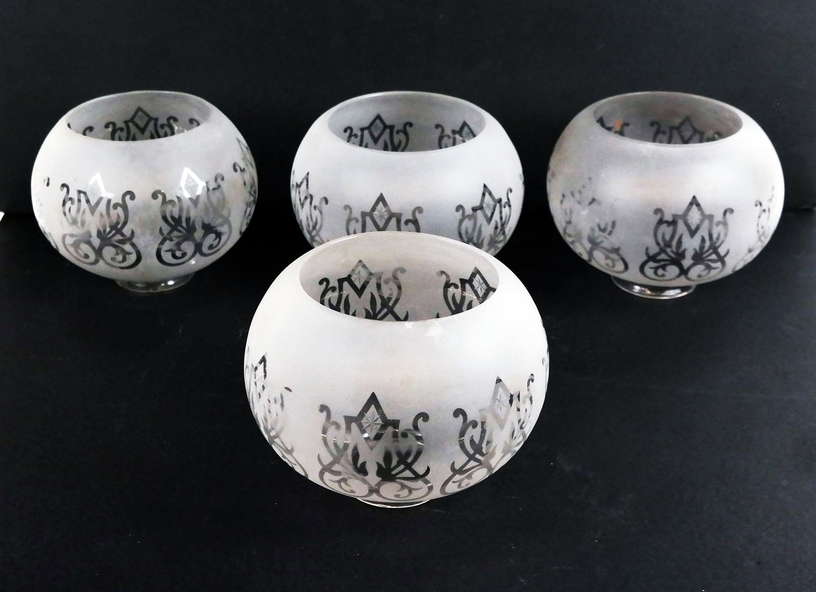 Set of 4 Frosted Glass Hurricane Shades: Set of four (4) clear-to-frosted glass globe hurricane shades. [5" H x 5" Diam.]. One with visible chip on larger rim.