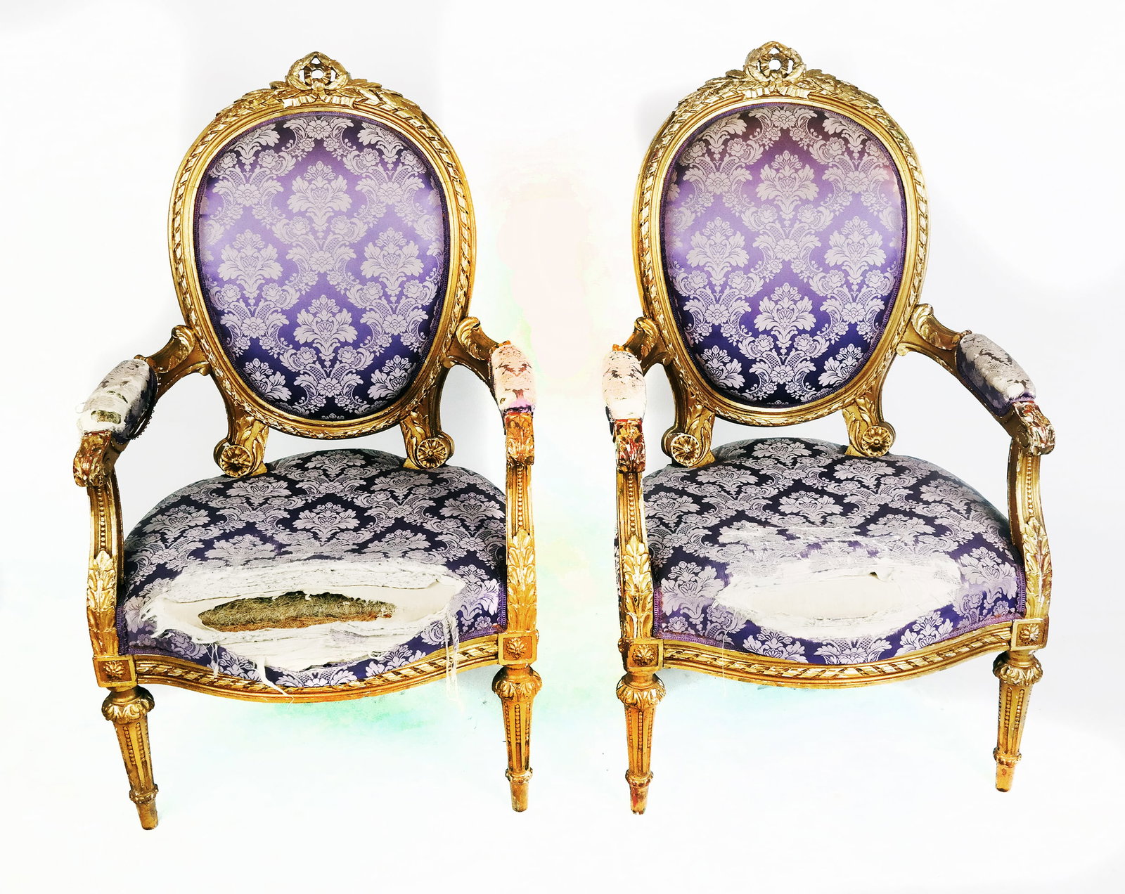 Pair of Gilt Carved Armchairs: Pair of Louis XVI style gilt carved fauteuils, Arm Pads and open floral backs. Upholstery in very poor condition. [41"H x 24"W x 27"D ]