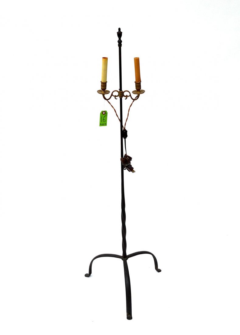 Wrought Iron and Brass Floor Lamp: Tripod base floor lamp with twist shaft and adjustable brass two light candleholder. In good condition. 15 1/2" Dia x 50 1/4" H.