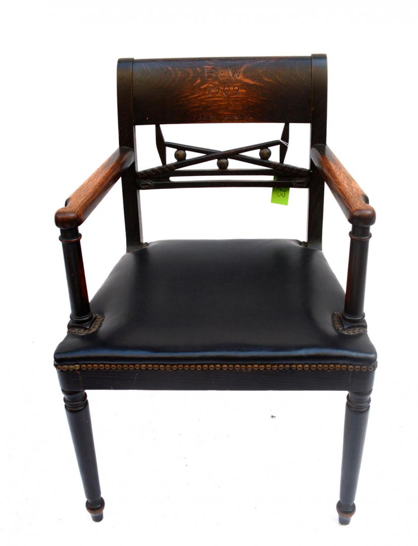 English Oak Armchair: Incised "B.W. from B.N.H." Black upholstery, open back. Back has carved polo mallets and balls. 22 1/2"L x 18 1/2"W x 34"H