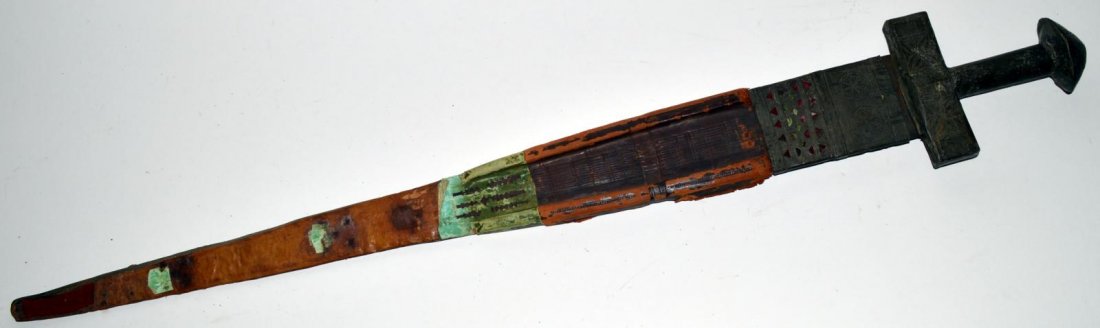 Antique Persian Double Edge Sword: Bears steel blade [29" L] and round handle with large pommel. Accompanied by leather scabbard. As is, needs restoration. Overall: 35" L.