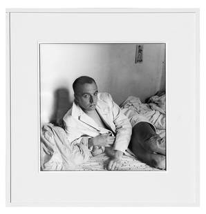 David ARMSTRONG: "Rene At His Apartment.." - Print: David Armstrong (American, 1954-2014) gelatin silver print depicting Rene Ricard laying in bed titled "Rene At His Apartment, E. 12th St., NYC," 1980. [Sight: 15 1/2" Diam.; Frame: 23 1/2" Diam.]. Pri