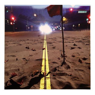 Photographic Print of Double Yellow Traffic Lines: Photographic print mounted on wood board depicting double yellow traffic lines over sand with a red flag, unsigned. [12" Diam. x 2 1/4" D]. Light wear and handling marks.