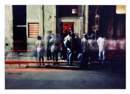 Contemporary Street Scene - C-print Photograph: Contemporary C-print photograph mounted on board depicting figures in a long exposure street scene, unsigned. [Overall:16" H x 23 3/4" W]. Light wear, scratches, and handling marks.