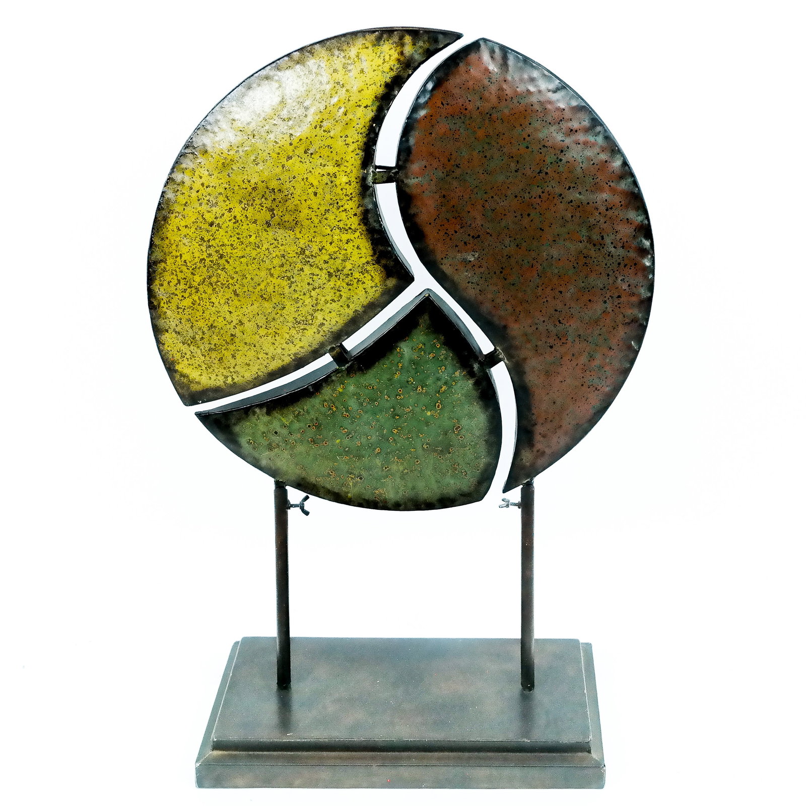 Modern Metal Peace Sign Sculpture: Modern metal peace sign sculpture in yellow, red, and green, raised on black metal stand. [Overall: 34" H]. Overall in good condition with light wear.