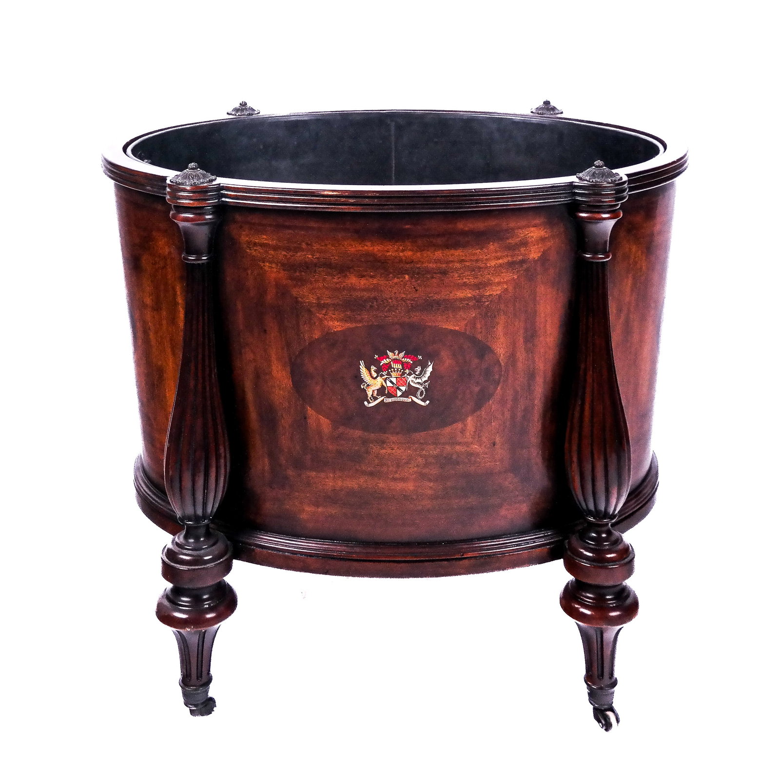 Regency-Style Mahogany Oval Wine Cooler: Regency-style oval mahogany wine cooler / cellarette, mid to late 20th century, having reed and bulbous-form legs, interior with a metal liner and raised on casters. The coat of arms is the heraldic a