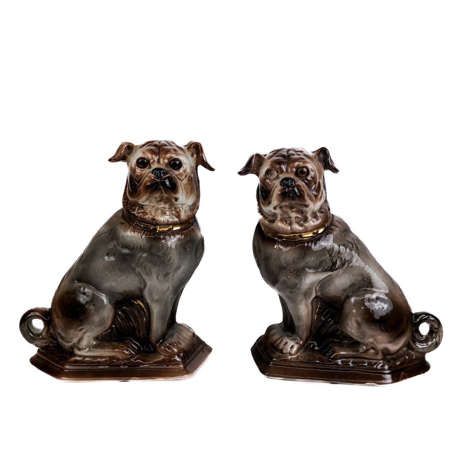 Pair of Staffordshire-Style Bulldogs: Pair of Staffordshire-style left- and right-facing bulldogs, in brown and white glaze, on self bases. [12 1/2" H x 10 1/2" W x 5" D]. One glass eye missing.