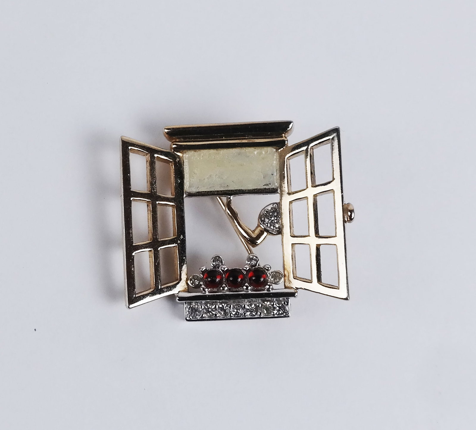 Flowers at a Window Brooch by Boucher: Costume brooch of flowers at an open window, by Boucher. [1" x 1 1/4"]. In good condition.
