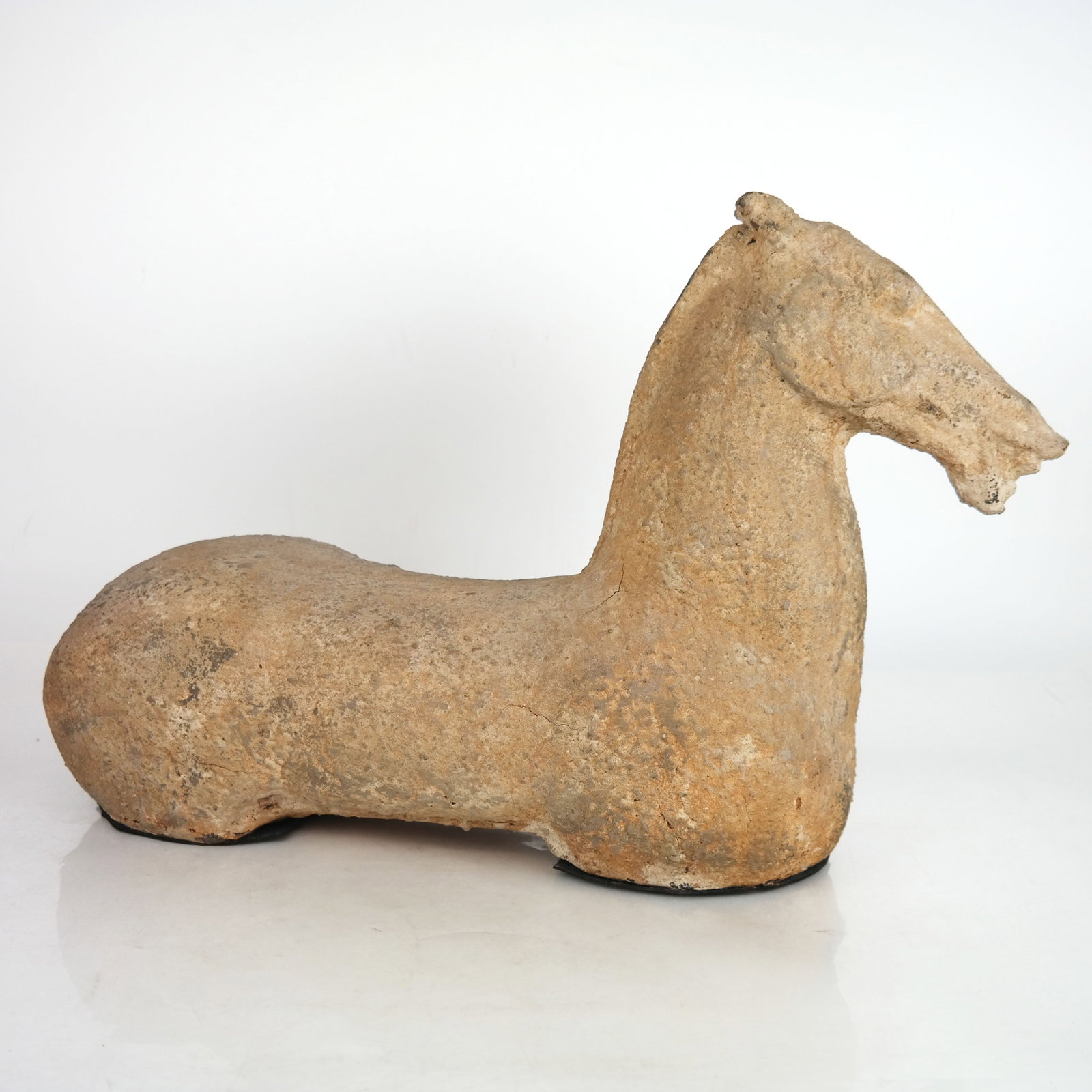 Chinese Sculpture of a Horse: Chinese sculpture of a horse, 20th century, in the Han Dynasty manner, after the antique. [13 1/2" H x 21 1/2" W x 6 1/2" D]. Scattered marks and wear.