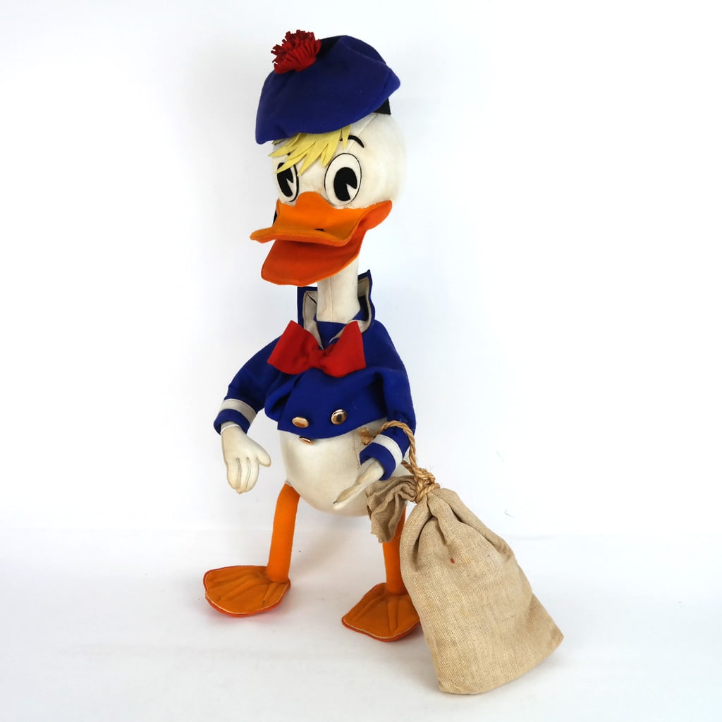 Lars Italian Felt Donald Duck: Lars Italian felt Donald Duck, mid-20th century, modeled as the iconic Disney character with Scottish tam hat and a pouch. Label not found. [20" H x 9 1/2" W x 8 1/2" D]. Scattered marks and wear.
