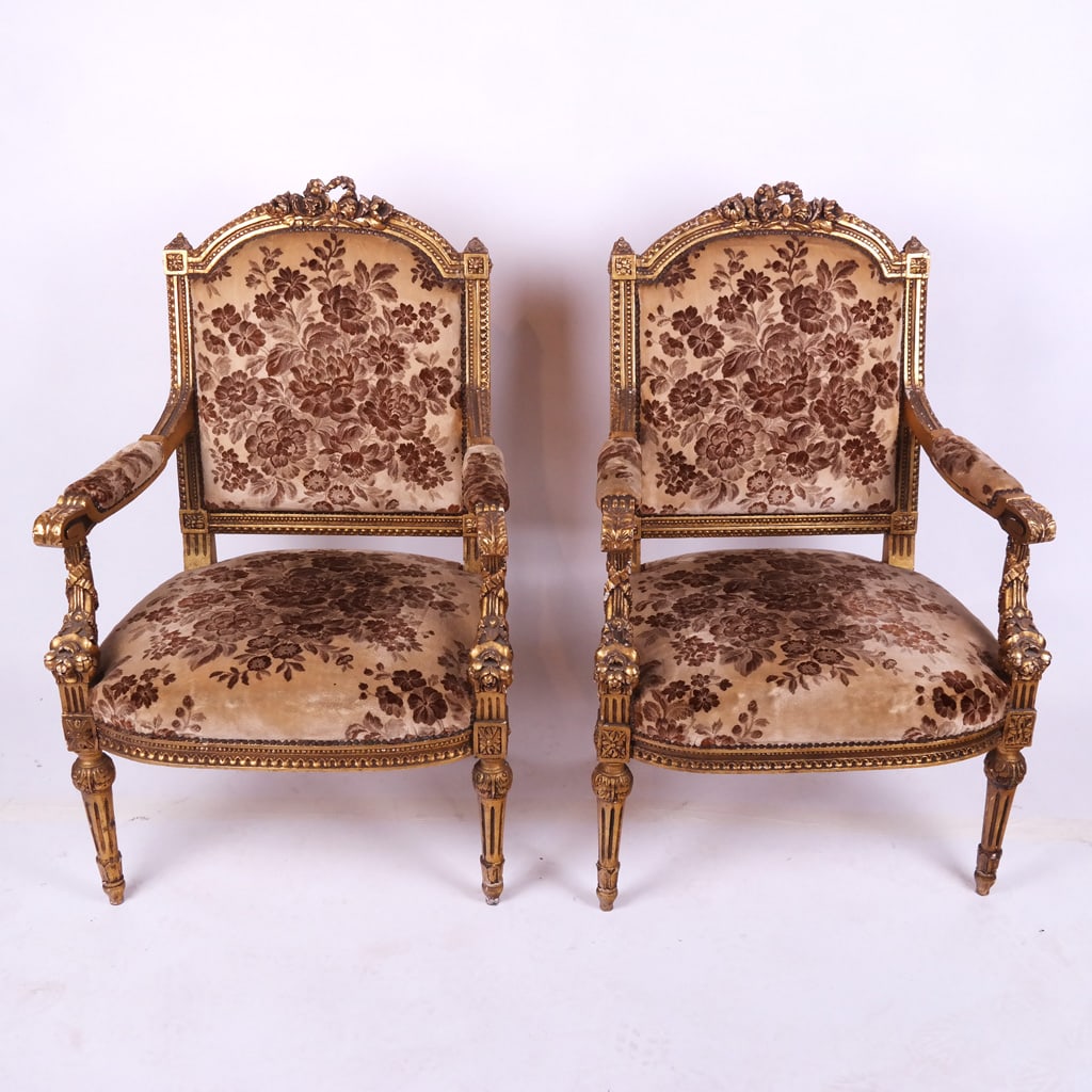 Pair of Carved Gilt Wood Fauteuils: Pair of floral velvet upholstered Louis XVI-style carved and gilt open armchairs, circa 1940s. [41" H x 27" W x 21" D]. Cracks and gilt wear as with age and use.