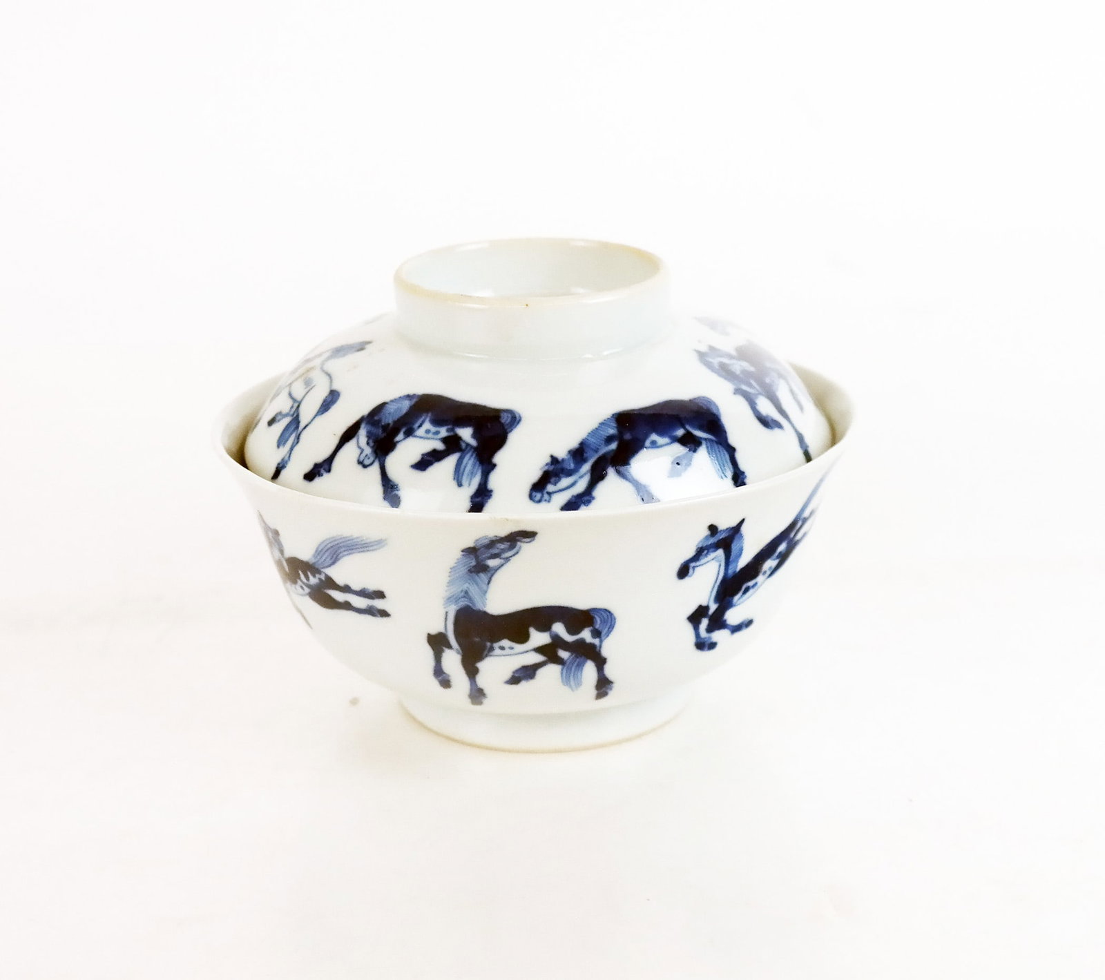 Chinese Blue & White Porcelain Bowl and Cover: Chinese blue and white porcelain bowl and cover, of equestrian interest, with repeating horse motifs of the Eight Imperial Horses of Wang Mu, the bases with four-character marks. [Overall: 4 1/2" H x 