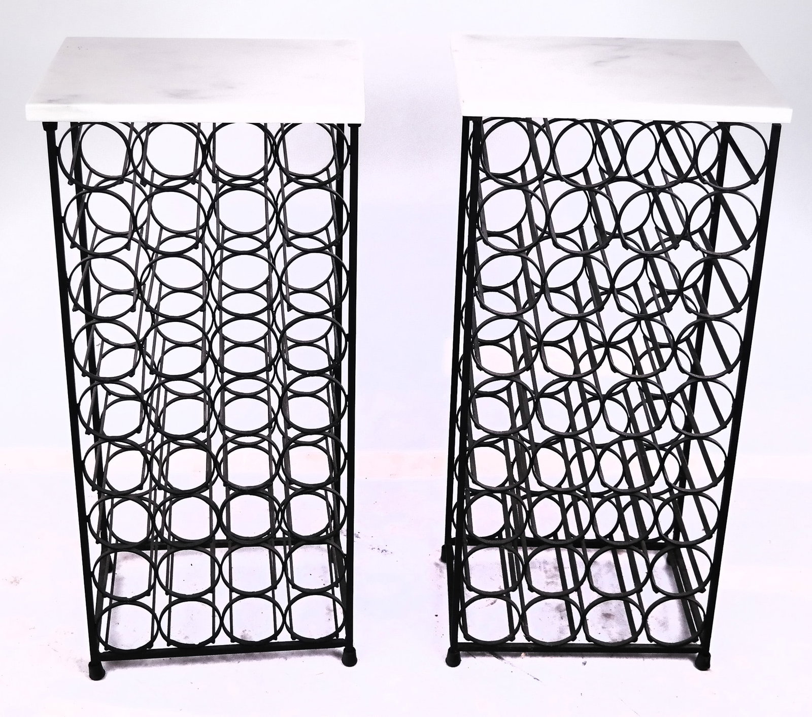 Two Iron Wine Racks: Two iron wine racks, each with a white marble top. [39" H x 17" W x 12" D]. Few minor chips to marble.