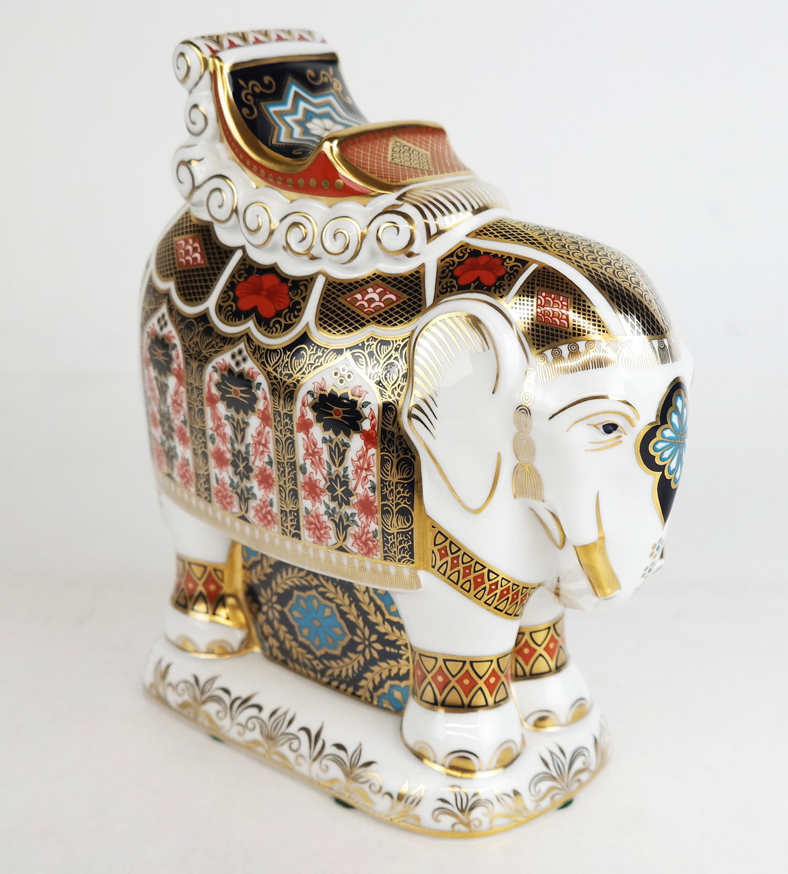 Royal Crown Derby Elephant Sculpture: English porcelain decorated sculpture of an elephant. [8 1/2" H x 7" W x 3" D]. In good condition.