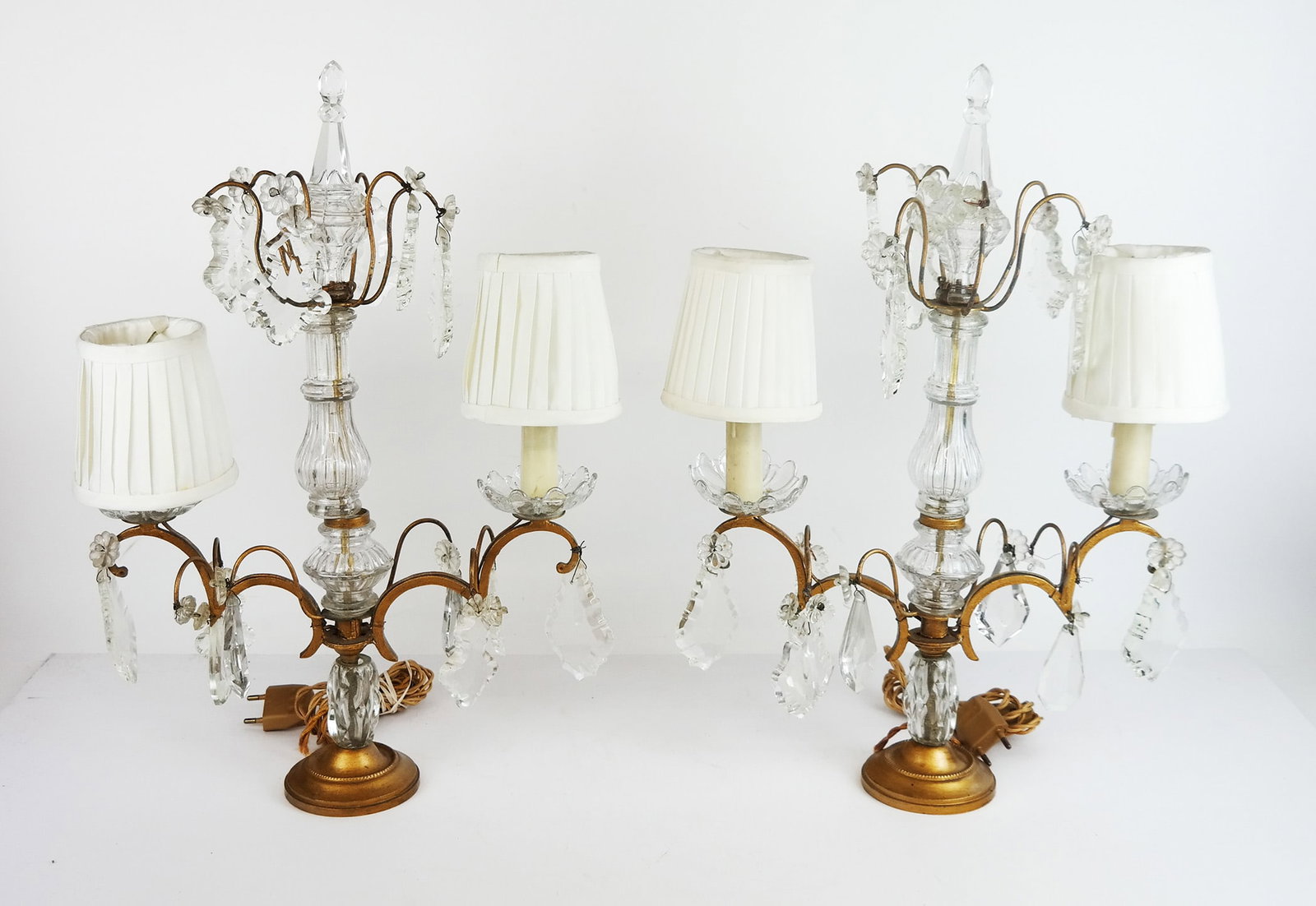 Pair of Continental 2-Light Girandoles: Pair of Continental crystal and matte gilt metal girandoles. [18 1/2" H x 12" L]. Some prisms detached but present.