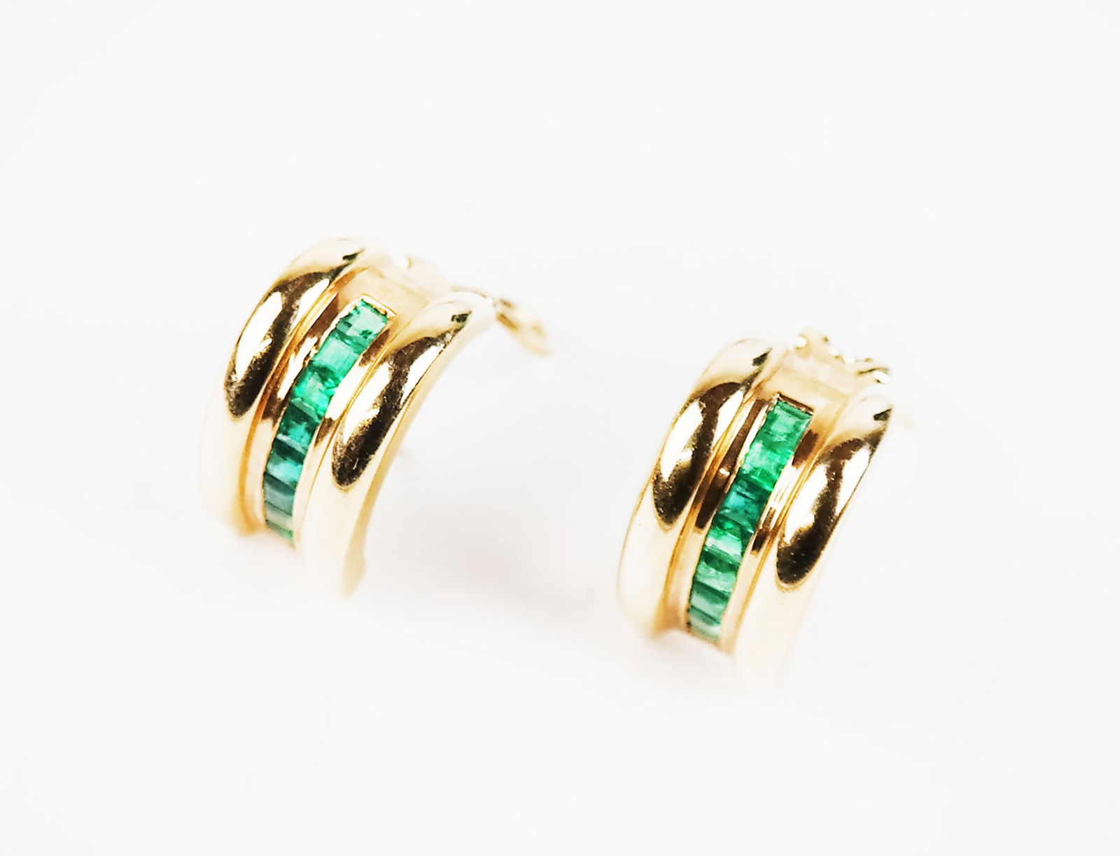 Cei Amoro Pair of Gold & Emerald Earrings: 14K gold earrings with 16 calibre set emeralds, signed "Cei Amoro", having clip backs with posts. 8.4 dwt. total. [7/8" H].