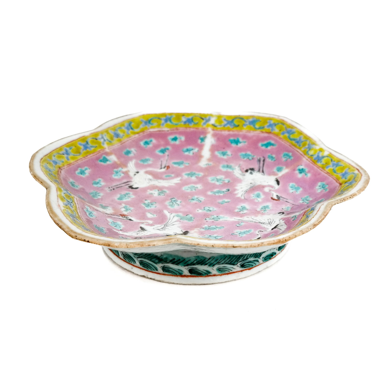 Chinese Famille Rose Porcelain Footed Dish: Chinese famille rose porcelain footed dish, late Republic period, with crane bird decoration on a pink ground with Imperial yellow border, the base with red chop seal mark. [2" H x 9" Diam.]. Hairline